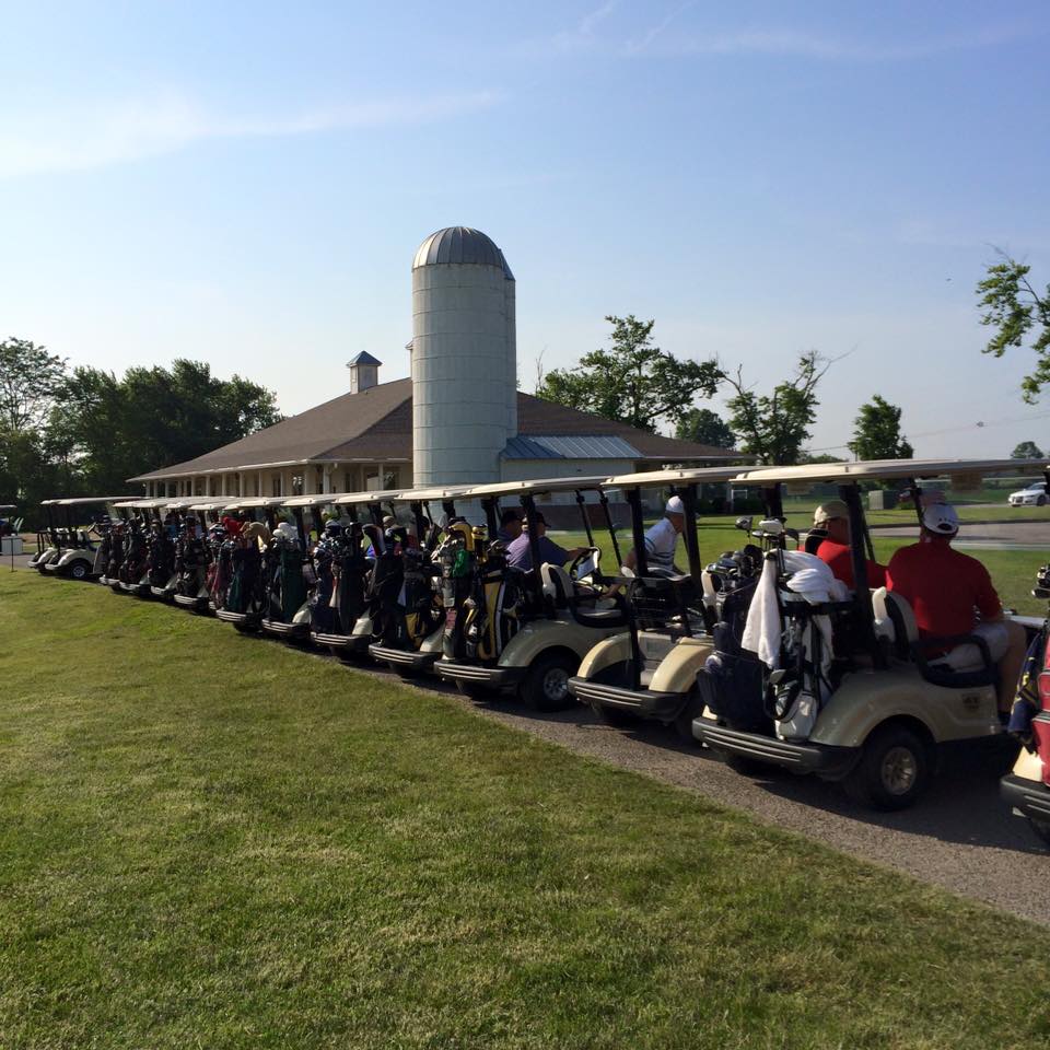 Players in golf carts on green